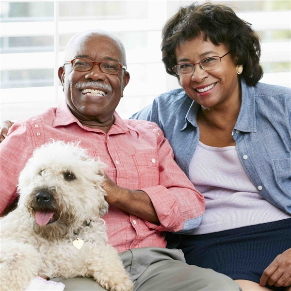 Smiling middle aged couple with dog